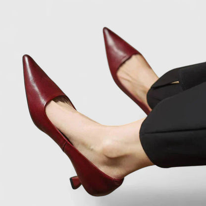 Burgundy pointed-toe slingback kitten heels with elastic back strap — side view on model