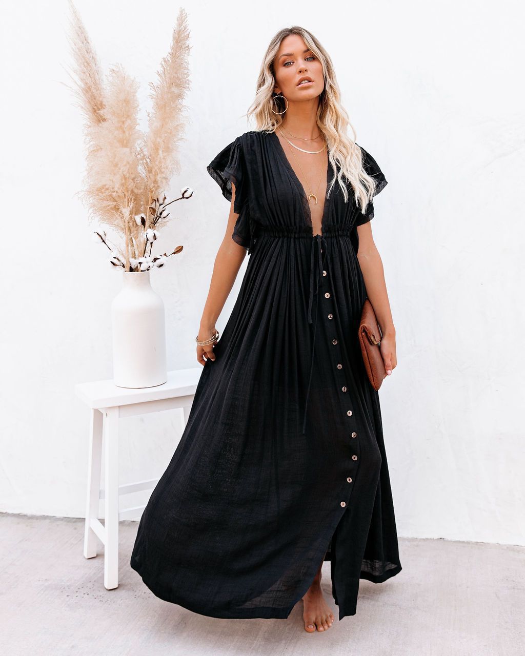 Black maxi dress with button-front detail and flutter sleeves — front view