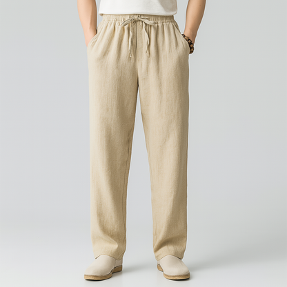 Beige linen drawstring pants with elastic waist and relaxed fit — front view