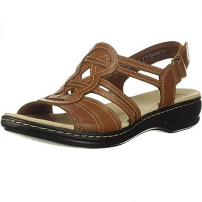 Women's brown leather strappy sandal with cushioned footbed and low wedge heel — side angle view