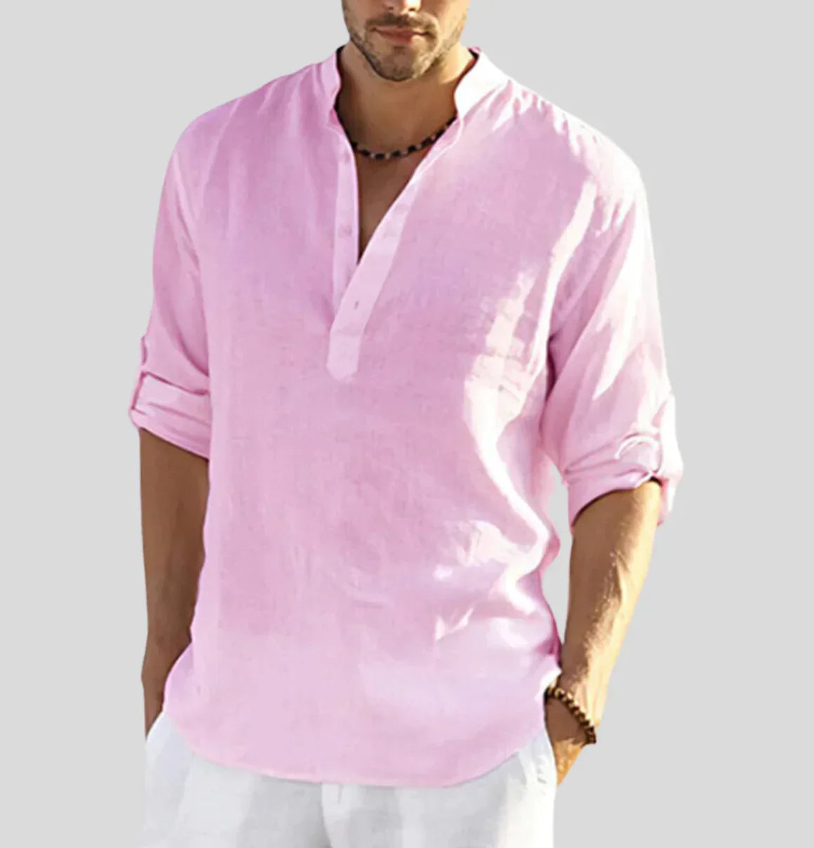 Pink linen henley shirt with rolled sleeves on male model — front view