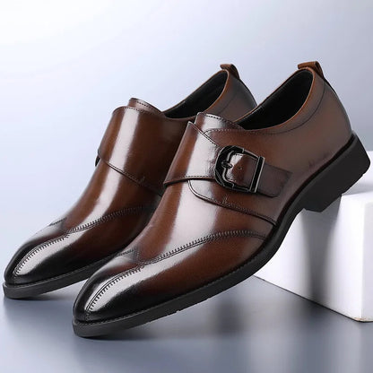 Brown monk strap dress shoes with buckle detail and burnished toe — three-quarter front view