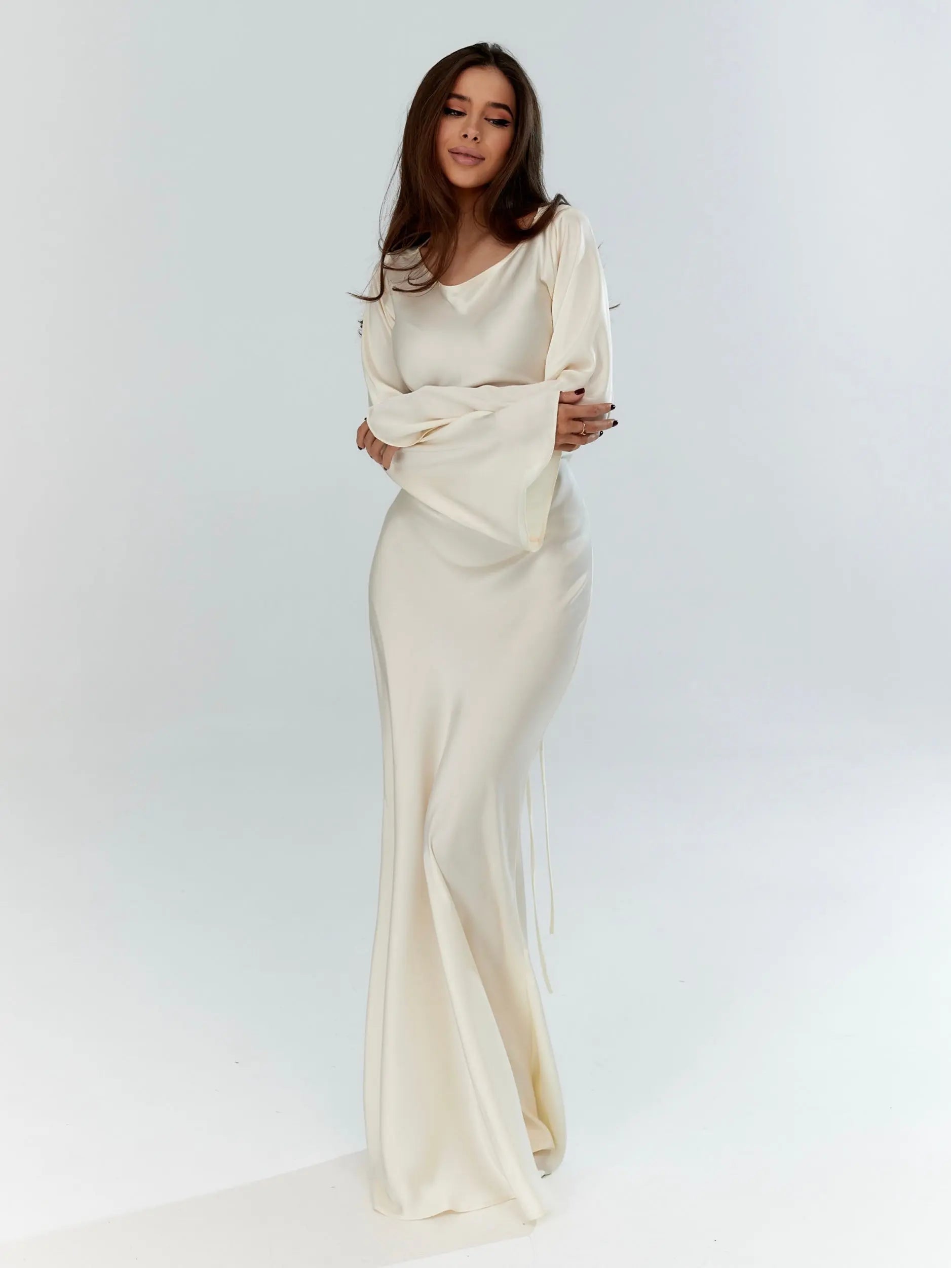 Cream satin long sleeve maxi dress with flowing silhouette — full length front view