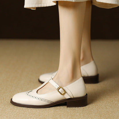 Women's cream leather brogue T-strap Mary Jane shoes with buckle closure — side view
