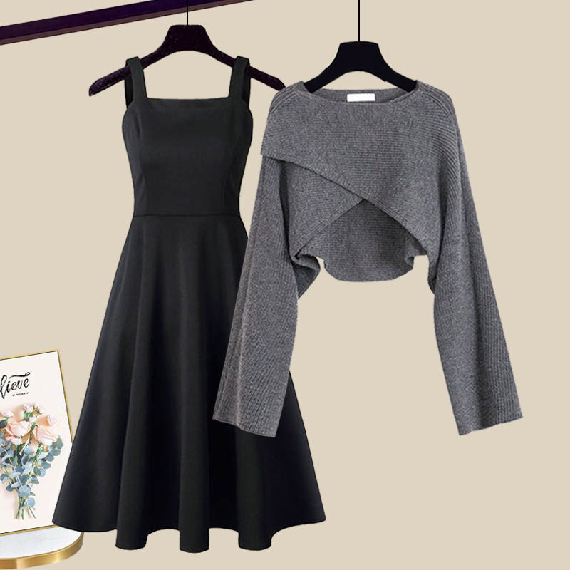Black A-line midi dress with spairing straps and gray wrap sweater on hangers — front view