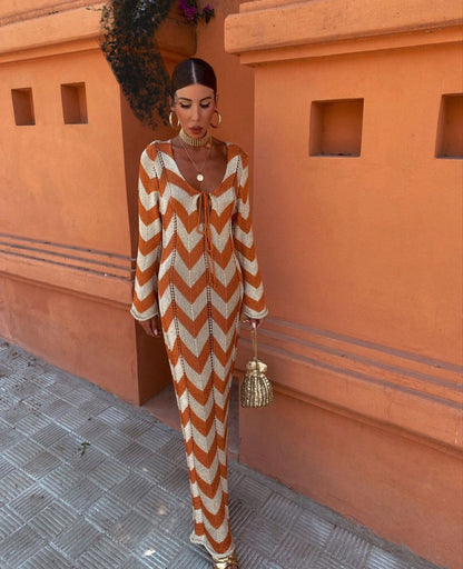 Chevron knit maxi dress with plunging neckline in rust and cream stripes — front view