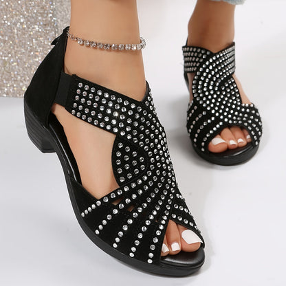 Black studded flat sandals with rhinestone embellishments and ankle ties — front angled view