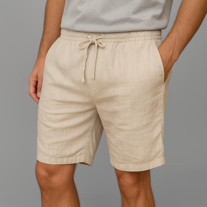 Men's beige linen drawstring shorts with elastic waistband — front view