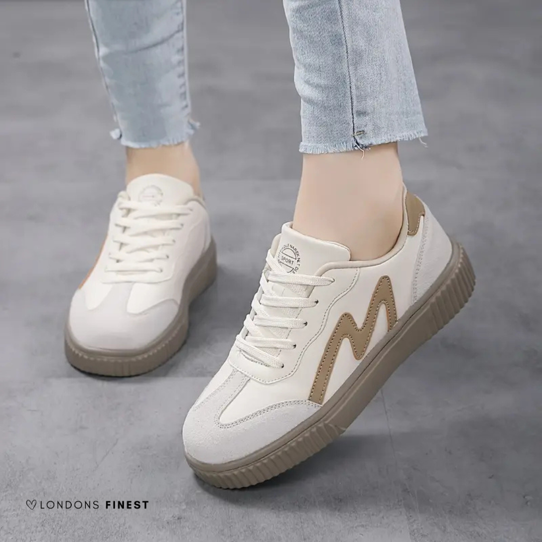 Women's white lace-up sneakers with tan M logo and platform sole — three-quarter side view
