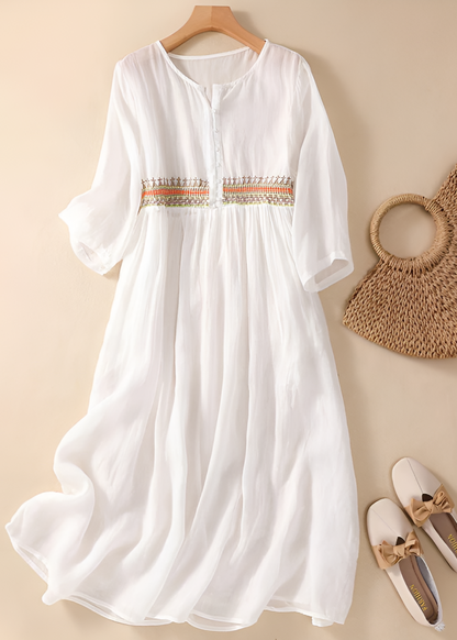 White midi dress with embroidered waist detail and three-quarter sleeves — flat lay view