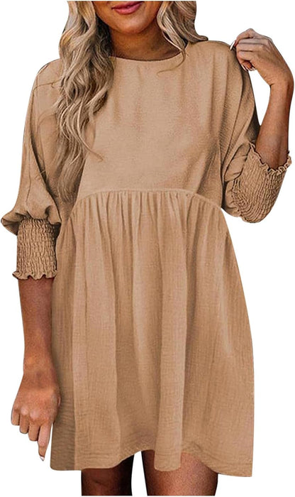 Women's beige babydoll dress with smocked ruffle cuffs — front view
