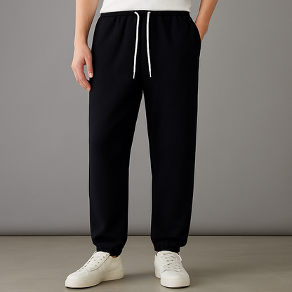 Black cotton drawstring joggers with white ties and side pockets — front view
