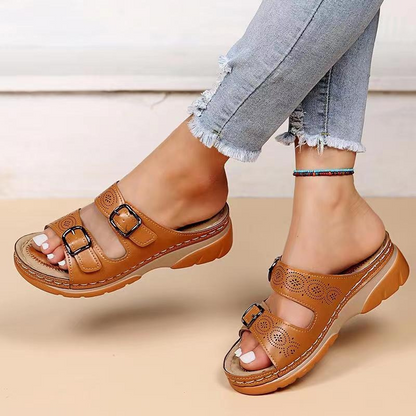 Women's tan orthopedic sandals with double buckle straps and decorative perforations — angled side view
