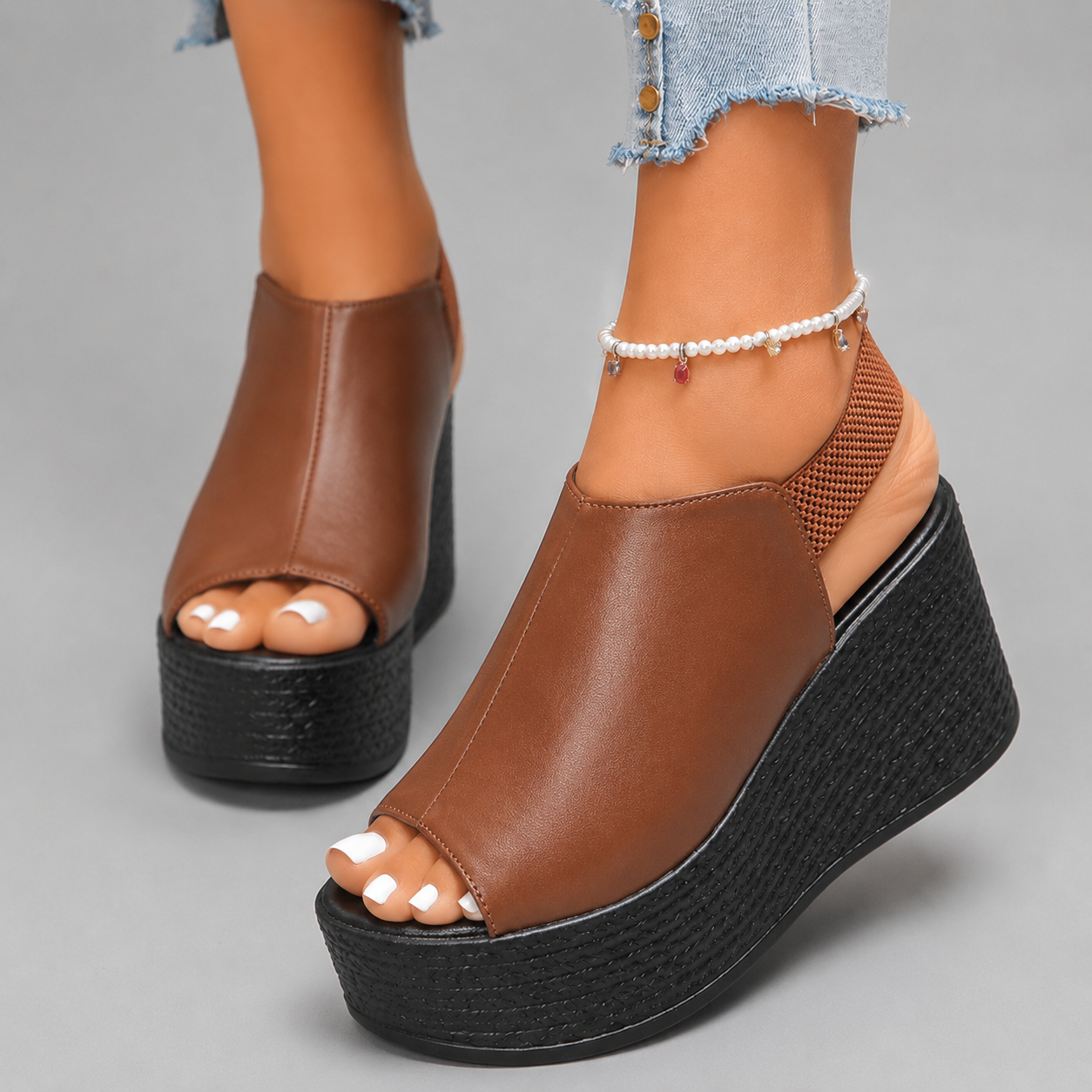 Brown leather peep-toe wedge platform sandals with textured heel detail — front angled view