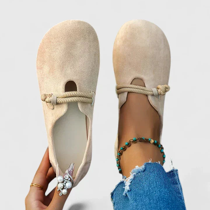 Women's beige suede orthopedic loafers with rope detail and keyhole cutout — overhead view with model wearing one