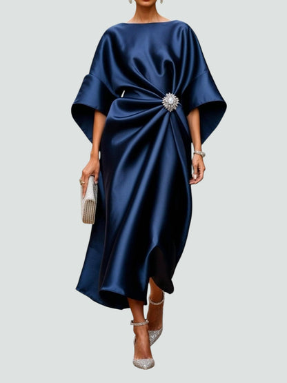 Navy blue satin evening maxi dress with crystal brooch waist detail and kimono sleeves — front view