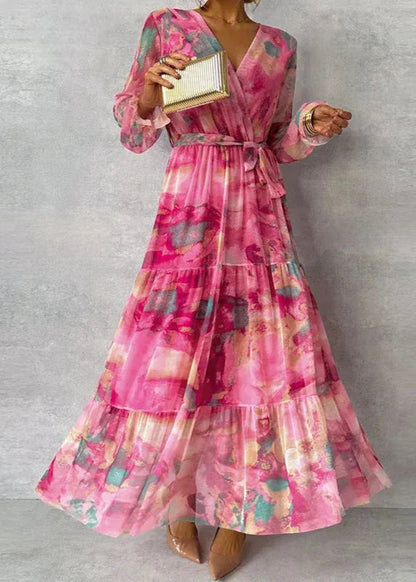 Pink floral tiered maxi dress with long sleeves and belt tie — front view