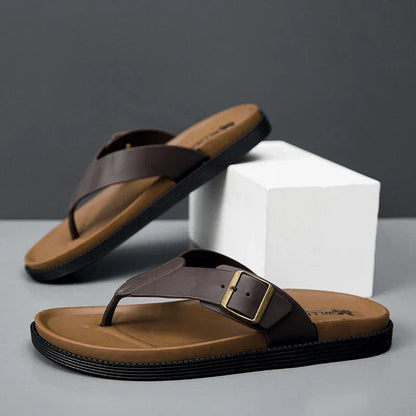 Brown vegan leather flip-flop sandals with buckle detail and tan footbed — angled side view