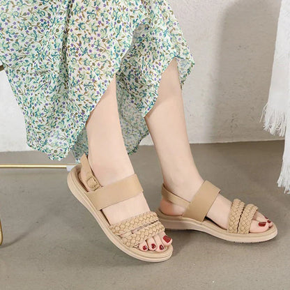Women's beige vegan leather sandals with braided straps and platform sole — side view on model