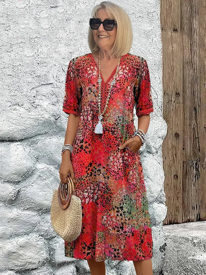 Women wearing colorful floral print midi dress with V-neck and pockets — front view