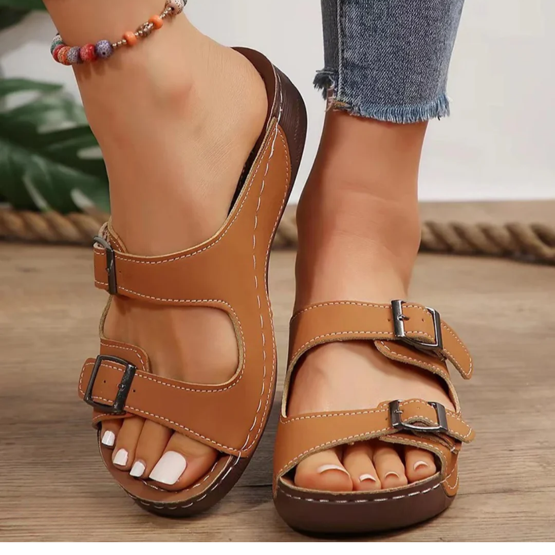 Women's tan leather orthopedic sandals with adjustable buckle straps — front three-quarter view
