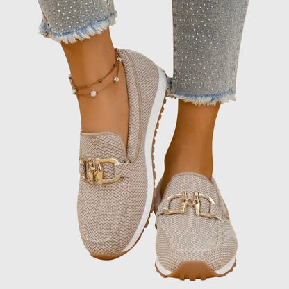 Women's beige textured loafers with gold buckle detail and white platform sole — front angled view