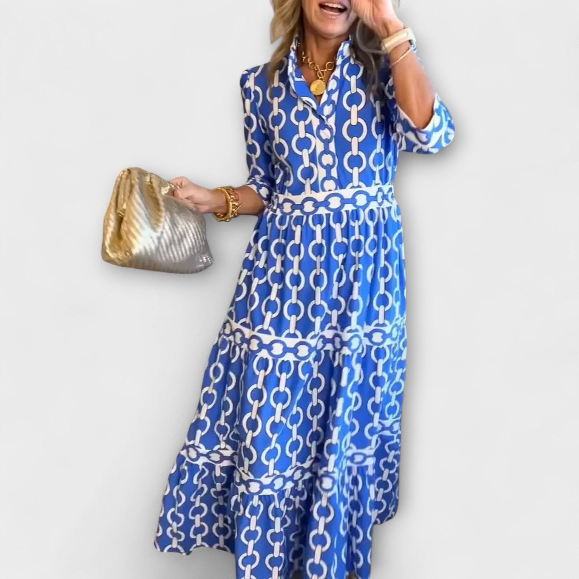 Blue and white chain print midi dress with tiered skirt and three-quarter sleeves — front view