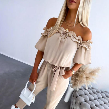 Women's beige off-shoulder jumpsuit with ruffle trim and tie waist — front view