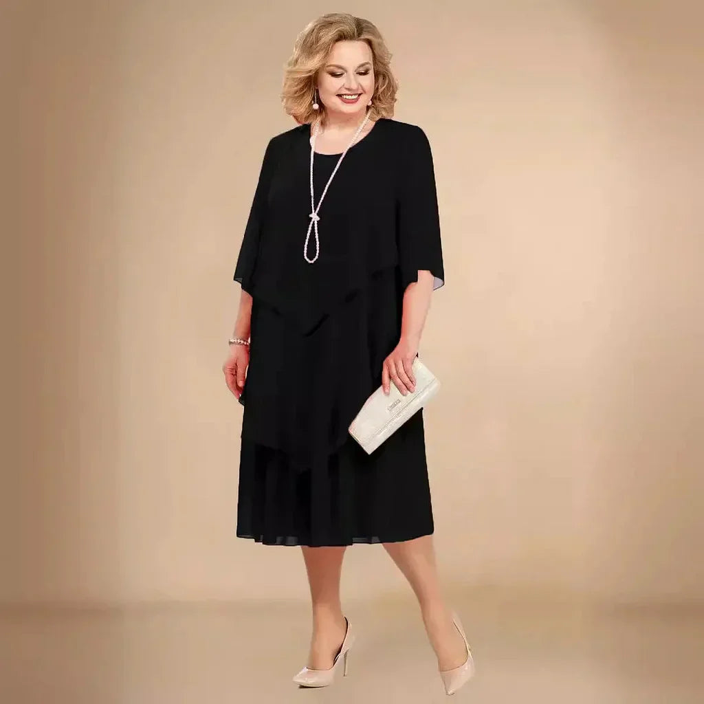 Black chiffon midi dress with asymmetric overlay and three-quarter sleeves — front view