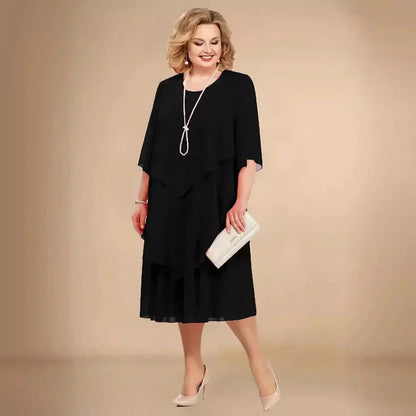 Black chiffon midi dress with asymmetric overlay and three-quarter sleeves — front view