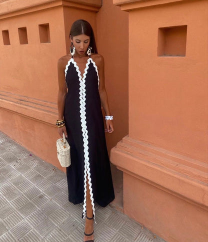Black maxi dress with white scalloped trim and halter neckline — front view on model