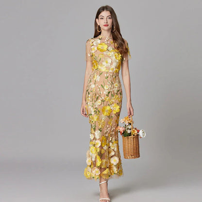 Women wearing yellow floral appliqué sheer maxi dress with wicker basket — front view