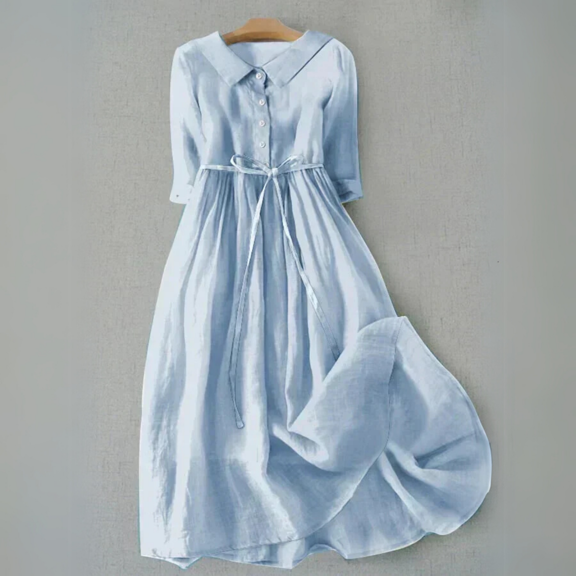 Light blue collared midi dress with button front and tie waist — front view on hanger