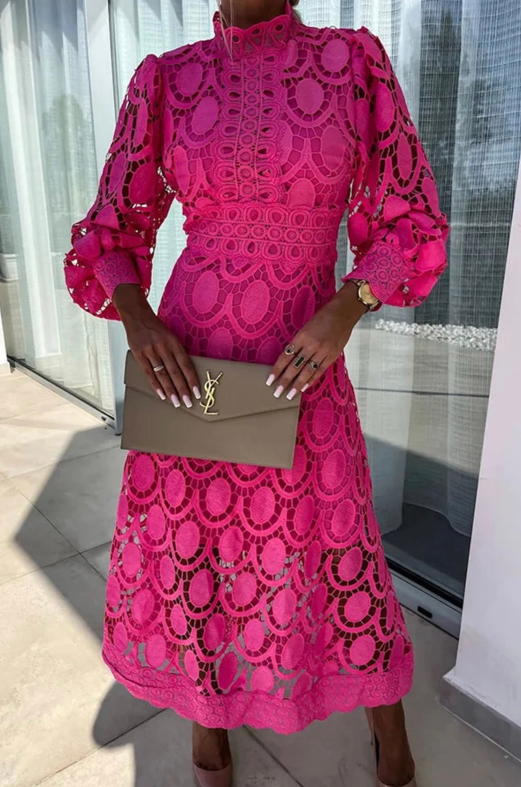 Hot pink lace midi dress with high neck and sheer sleeves — front view on model