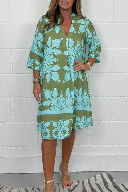 Women's olive green and turquoise floral print midi dress with bell sleeves — front view