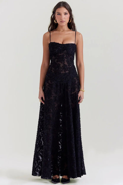Black textured maxi dress with spaghetti straps and floral appliqué details — front view