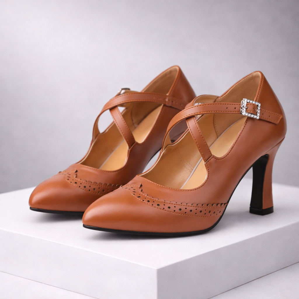 Women's tan leather T-strap block heels with brogue detailing and rhinestone buckle — three-quarter front view
