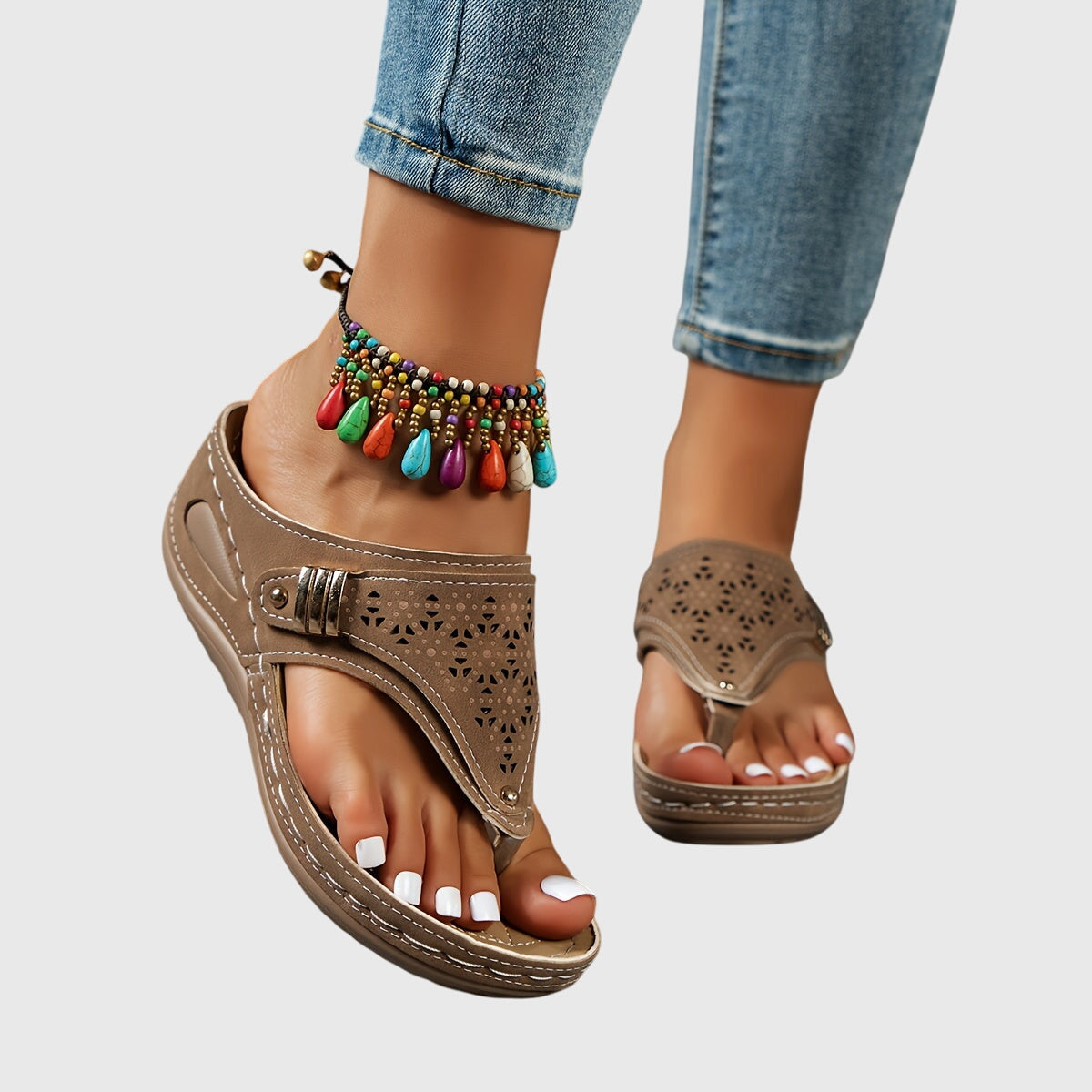 Women's tan platform sandals with laser-cut detail and colorful beaded anklet — angled side view
