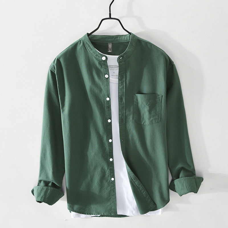 Green collarless cotton shirt with white buttons over white tee on hanger — front view