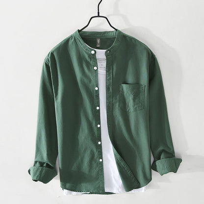 Green collarless cotton shirt with white buttons over white tee on hanger — front view