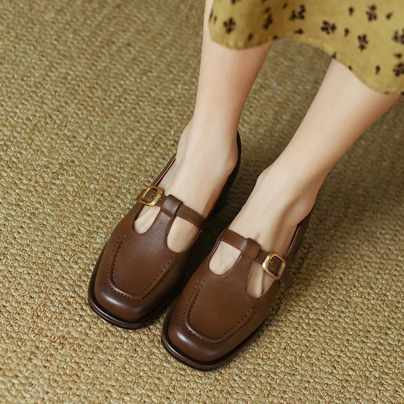 Brown T-strap Mary Jane shoes with square toe and gold buckle — overhead view on feet