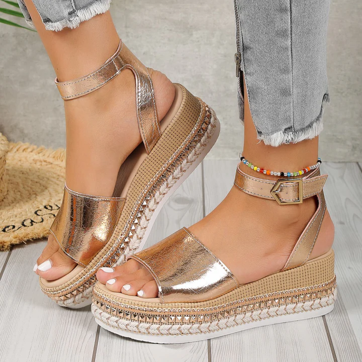 Rose gold platform sandals with ankle strap and espadrille wedge — three-quarter front view