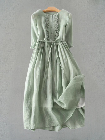 Sage green linen midi dress with ruffle front detail and tie waist — front view