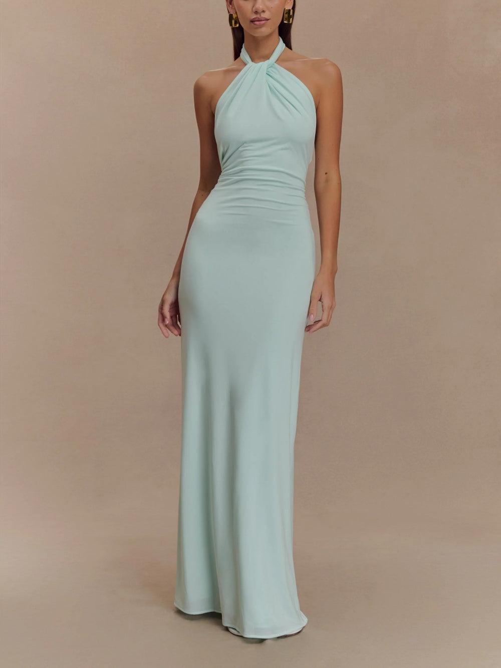 Elegant halter neck maxi dress in soft sage green with ruched waist detail — front view