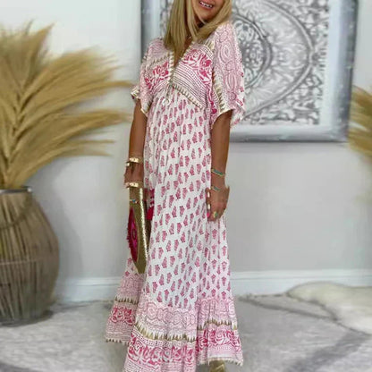 Bohemian maxi dress with pink paisley print and empire waist — three-quarter side view