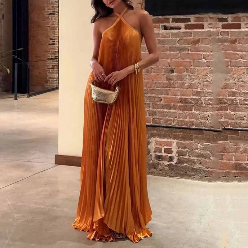 Orange pleated halter maxi dress with flowing silhouette — front view