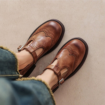 Brown leather Mary Jane sandals with wingtip brogue detailing on chunky black soles — top-down view