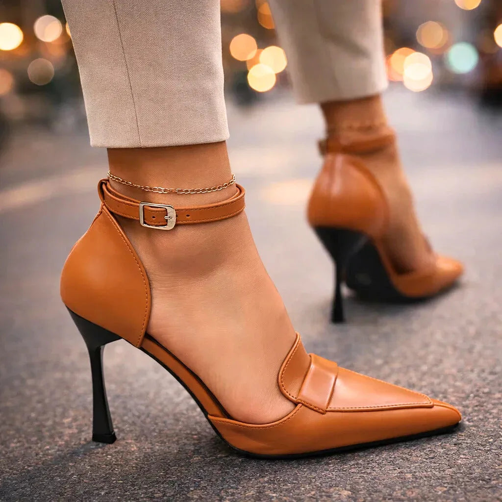 Tan pointed toe heels with ankle strap and black stiletto heel — side view