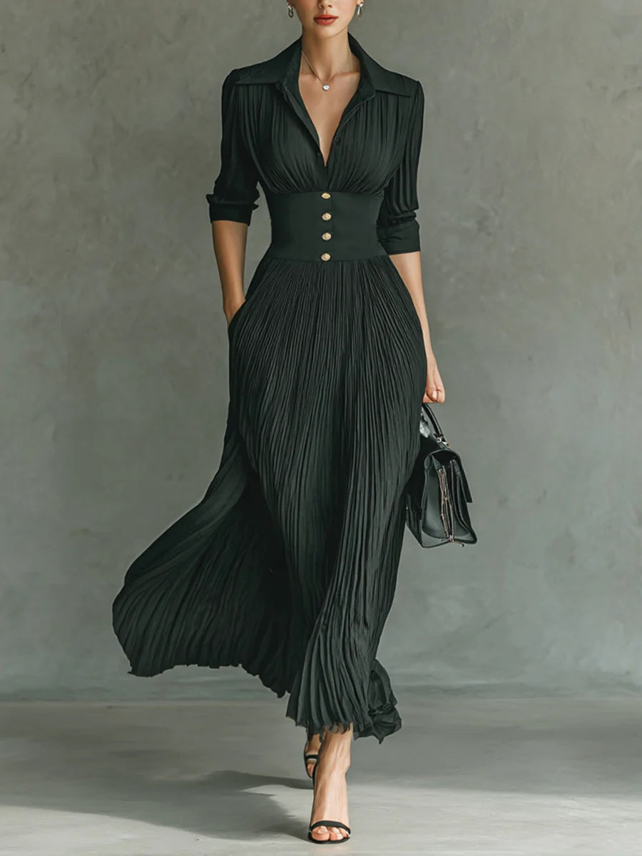 Elegant dark green pleated maxi dress with collar, fitted waist, and button detail — front view