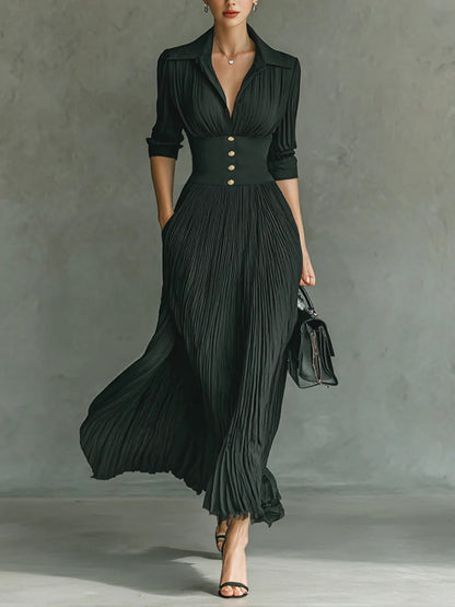 Elegant dark green pleated maxi dress with collar, fitted waist, and button detail — front view